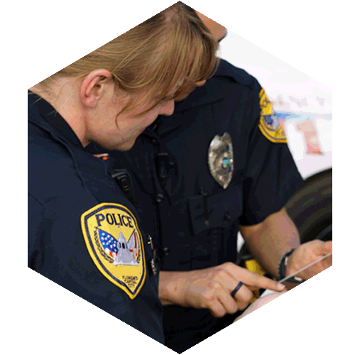 Two Police Officers on duty checking online resources.