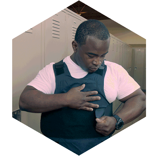 Male Police Officer fixing vest.