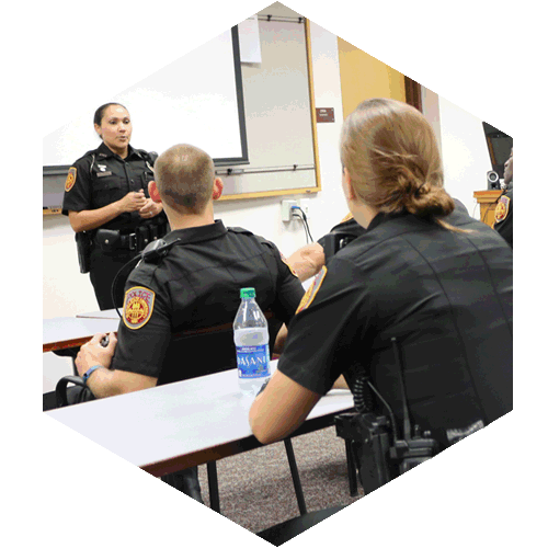 Police Officers sitting in class room.