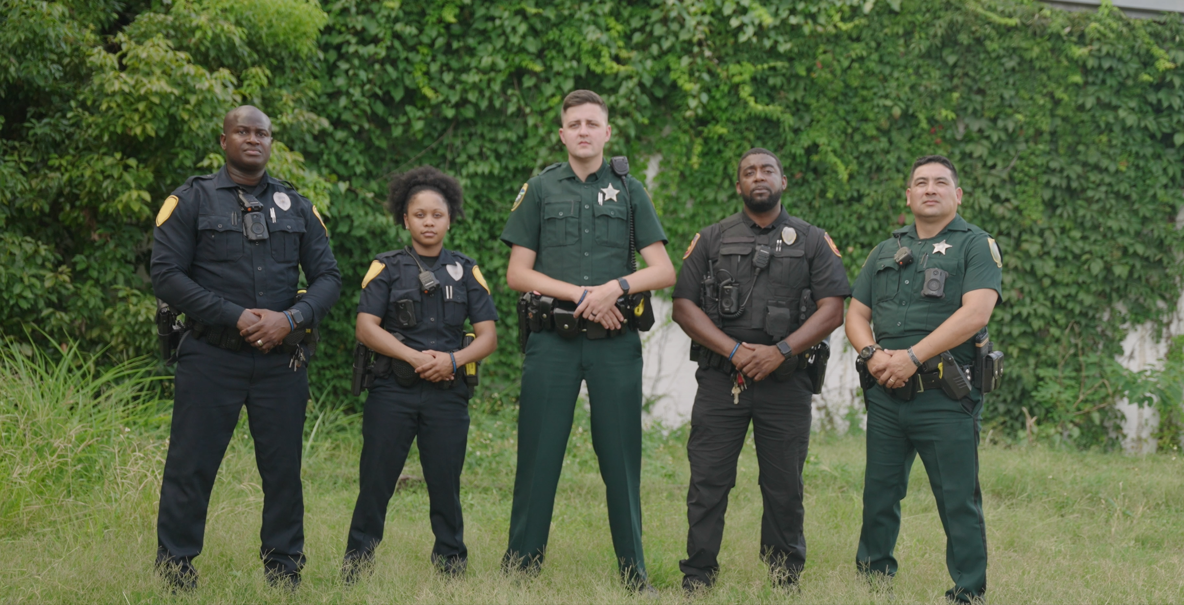 Five police officers standing together outside