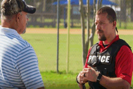 Male police officer talking to citizen
