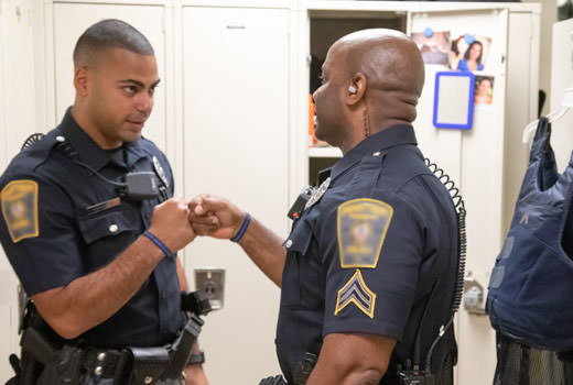 Two officers fist bumping