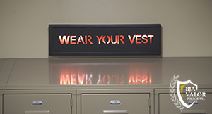 Episode 4 Thumbnail, locker room with sign wear your vest.